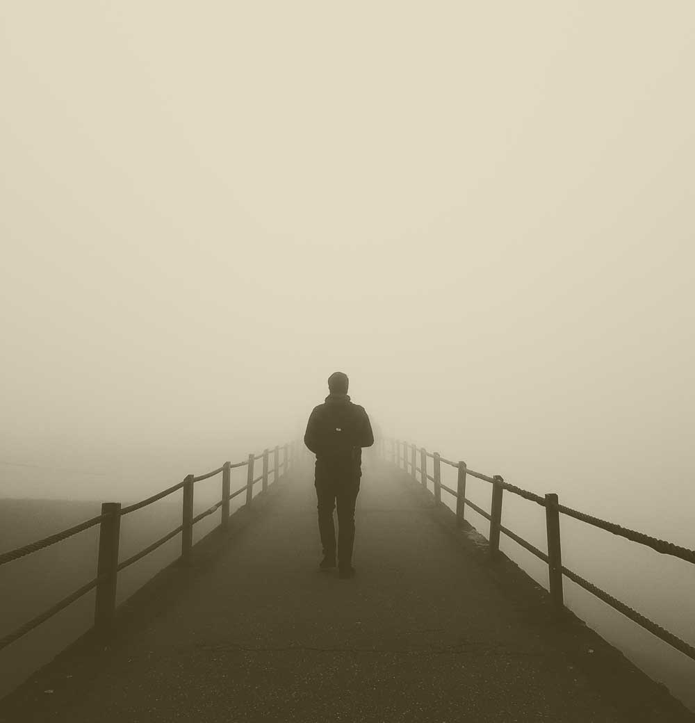 A man stairing into the fog.