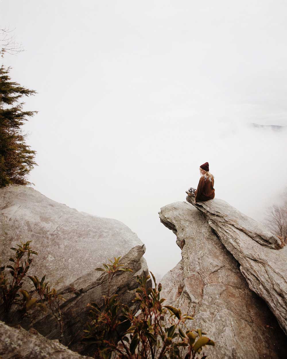 A woman on a rock in the fog